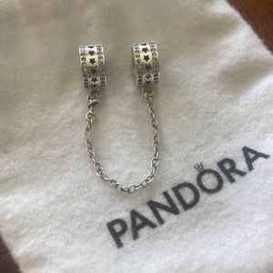 Pandora (this one is NOT authentic) but is sterling silver. Star security clip